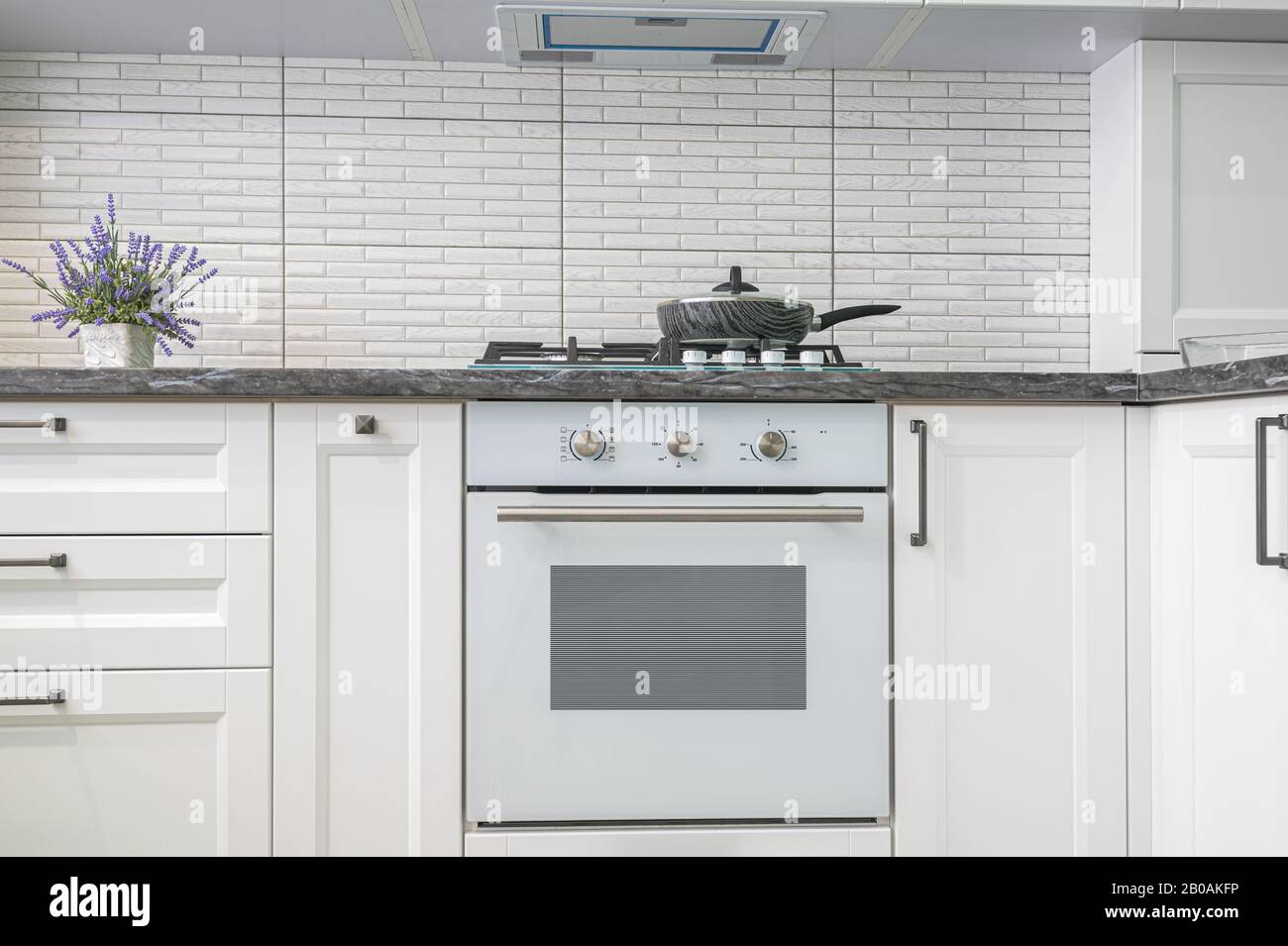 Modern white kitchen interior, front view Stock Photo - Alamy