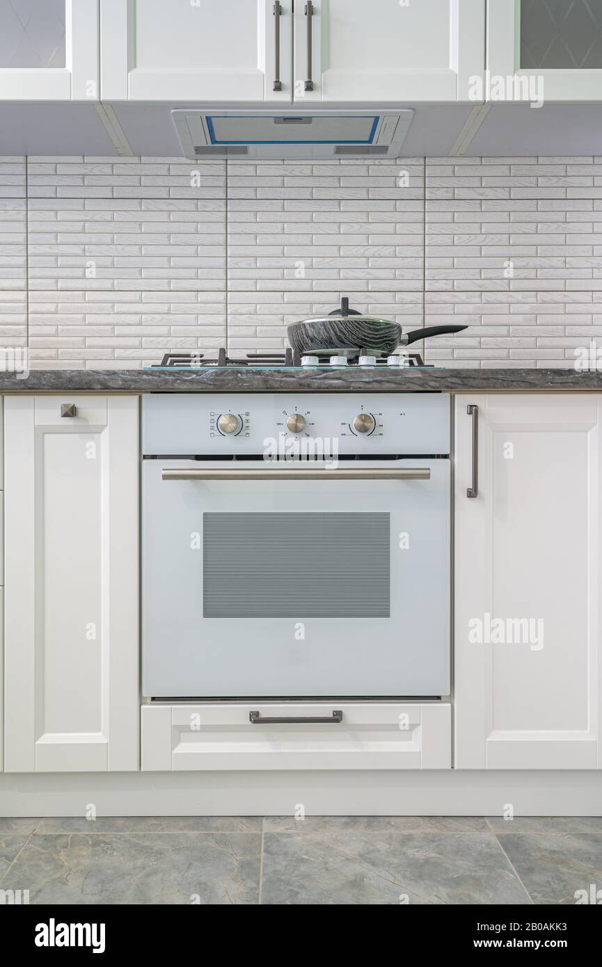 Modern white kitchen interior, front view Stock Photo - Alamy