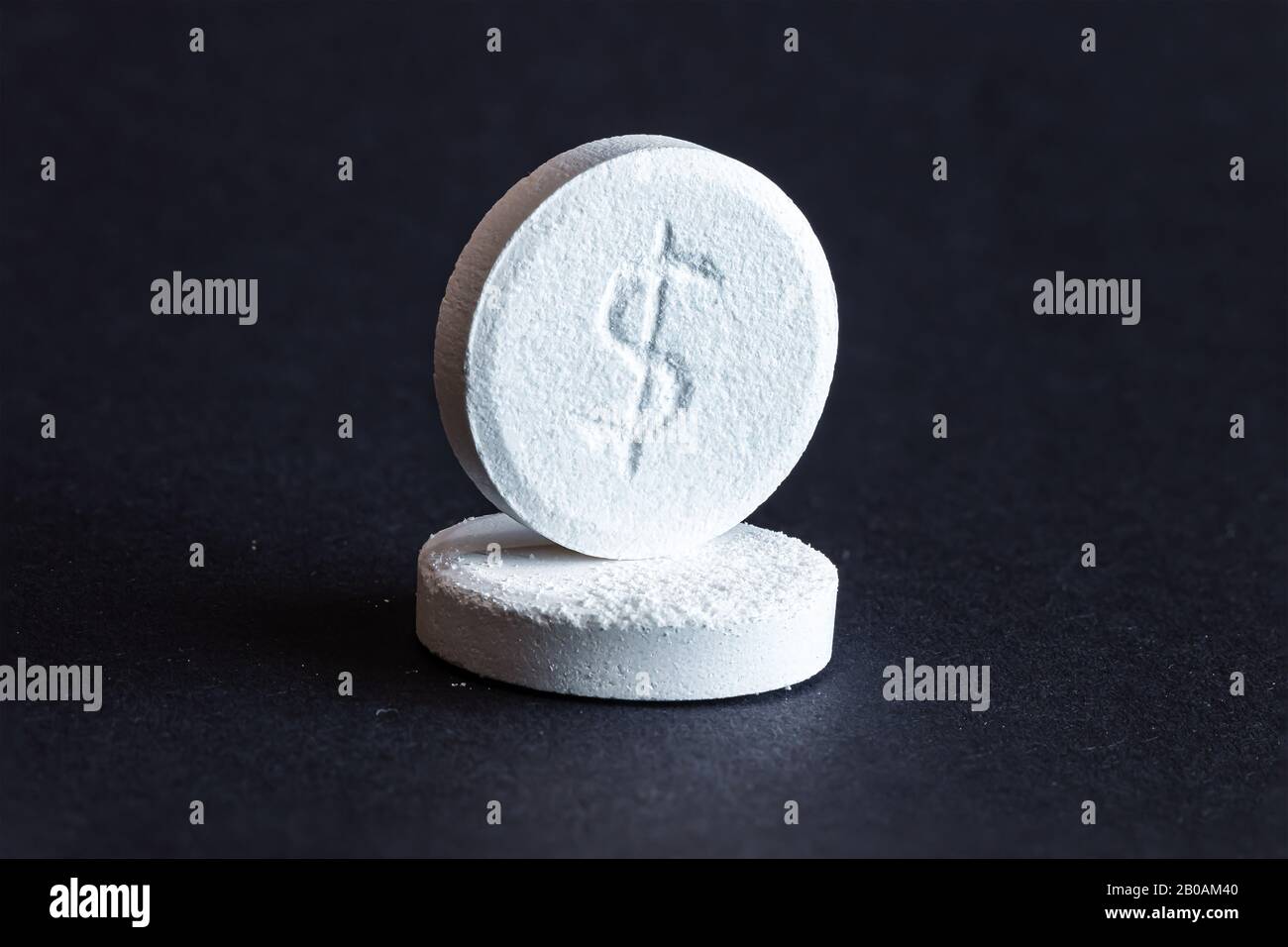 Two pills with dollar sign engraved Stock Photo