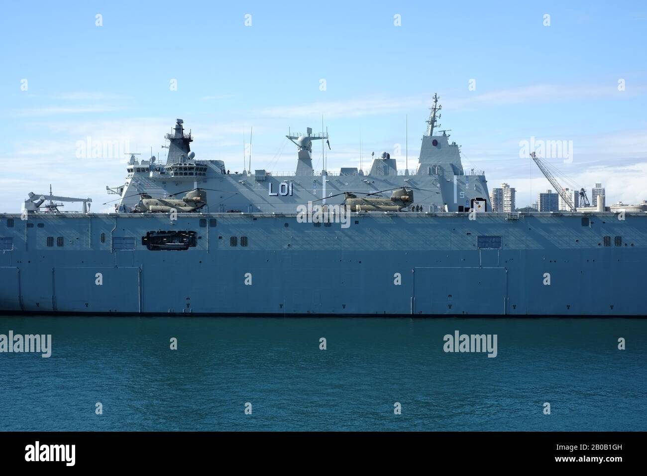 HMAS Adelaide (L01) berthed at Cowper Wharf, HMAS Kuttabul, Woolloomooloo, Australia Stock Photo