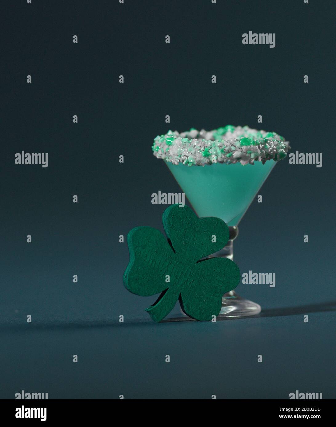 St. Patrick's Green, Sugar Rimmed, Confetti Cocktail with Wooden Shamrock Stock Photo