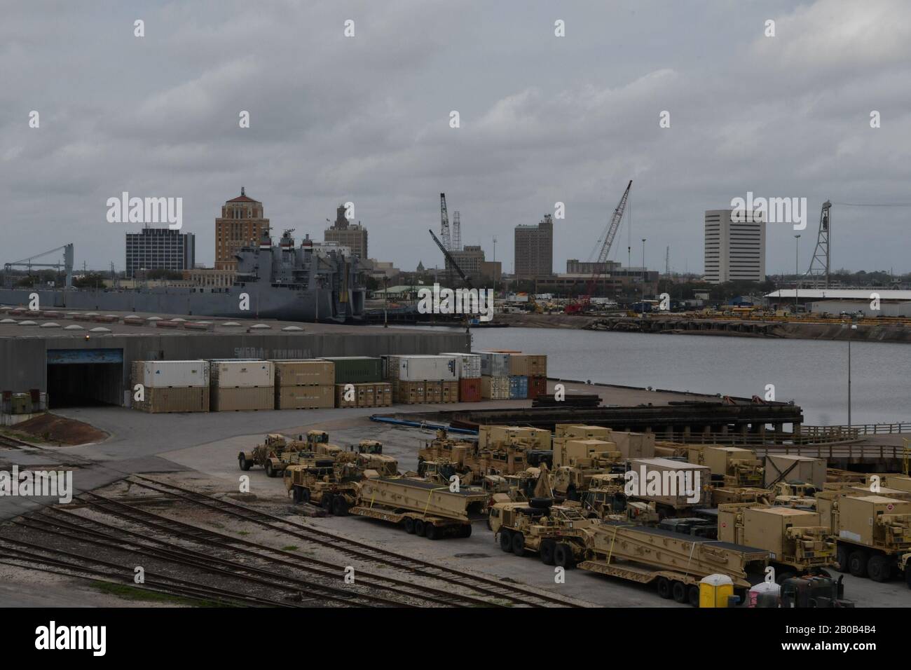 Containers and vehicles await transportation on commercial ships to Europe in support of DEFENDER-Europe 20 February 18, 2020 at the Port of Beaumont, Texas. DEFENDER Europe 20 will exercise the deployment of a division-size combat-credible force from the United States to Europe, the drawing of equipment and the movement of personnel and equipment across the theater to various training areas. U.S. Army photo/Kimberly Spinner) Stock Photo