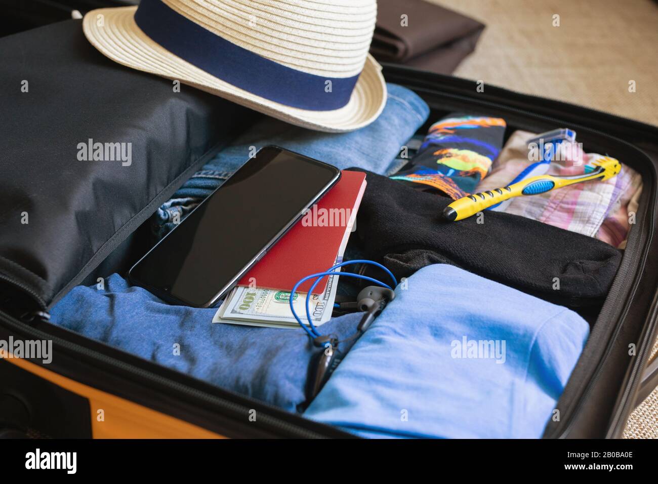 https://c8.alamy.com/comp/2B0BA0E/concept-preparation-for-trip-or-travel-open-suitcase-with-mens-clothing-2B0BA0E.jpg