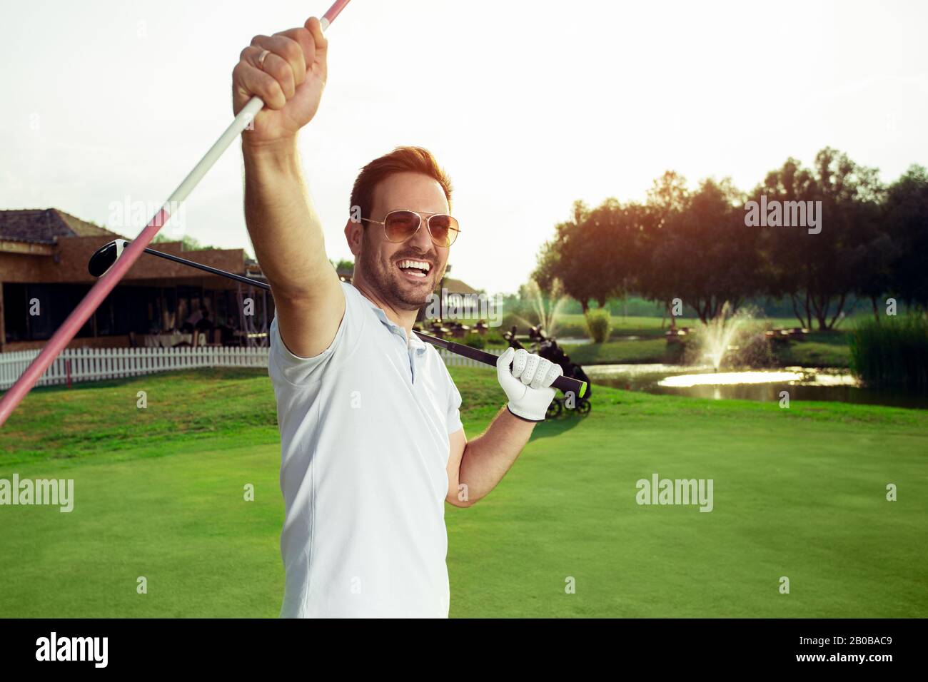 A handsome male golfer is celebrating his win. Stock Photo