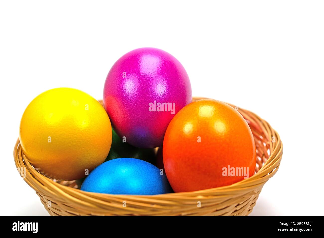 Colorful Easter eggs in basket against white background Stock Photo - Alamy