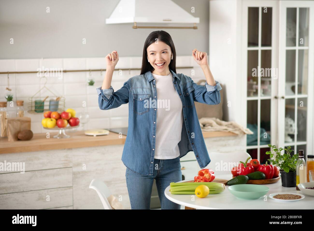 Young girl in headphones dancing in the kitchen Stock Photo Alamy