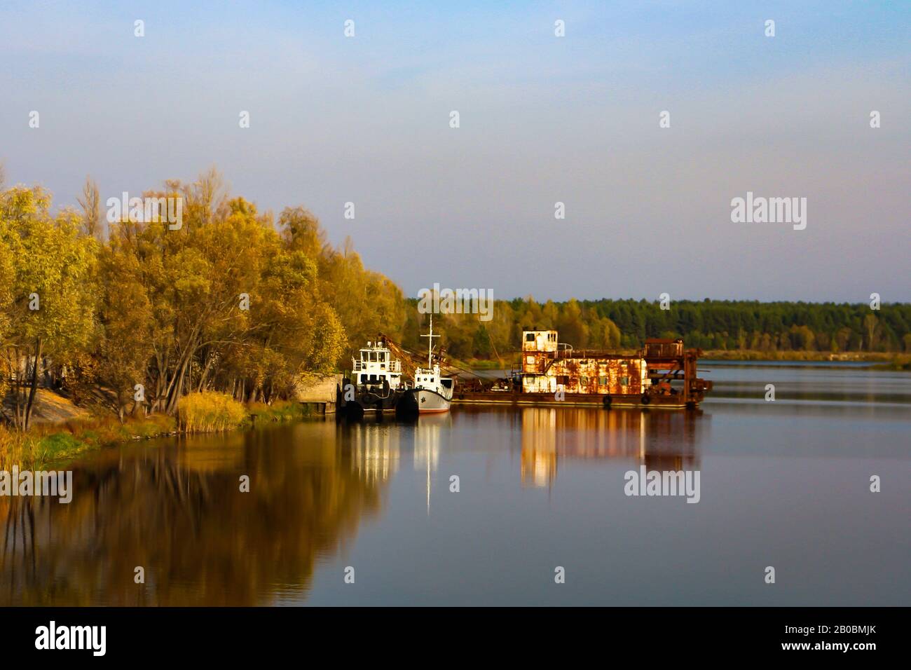 Rusty shipwrecks on Pripyat river in the Chernobyl exclusion zone as seen from Chernobyl town, Ukraine. Stock Photo