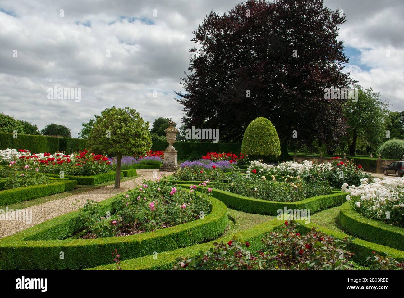 A formal English garden in Summer at Grimsthorpe Castle, Lincolnshire, UK Stock Photo