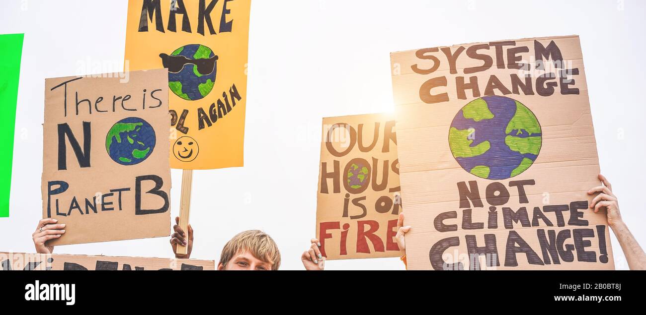 Group of demonstrators on road, young people from different culture and race fight for climate change - Global warming and enviroment concept - Focus Stock Photo