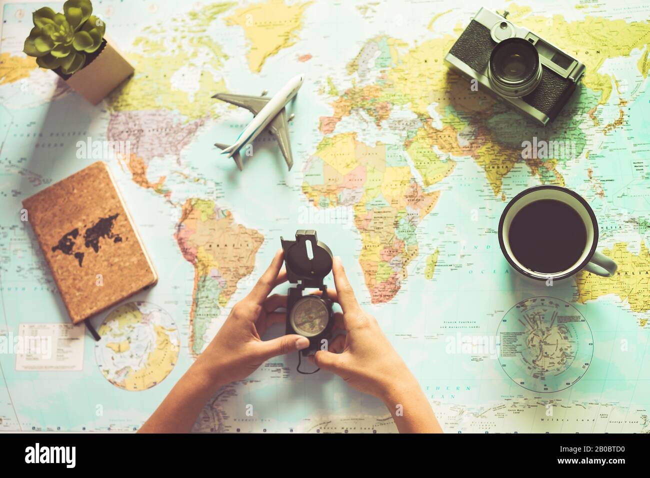 Young woman drinking coffee and planning world tour with vintage travel map - Backpacker girl looking for a new countries to explore - Journey trends, Stock Photo