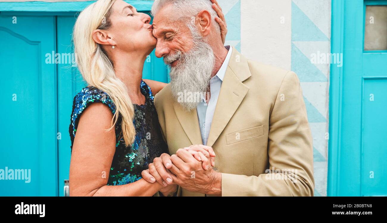 Happy senior couple having tender moments outdoor - Mature people enjoying time together - Love, fashion and joyful elderly active lifestyle concept - Stock Photo