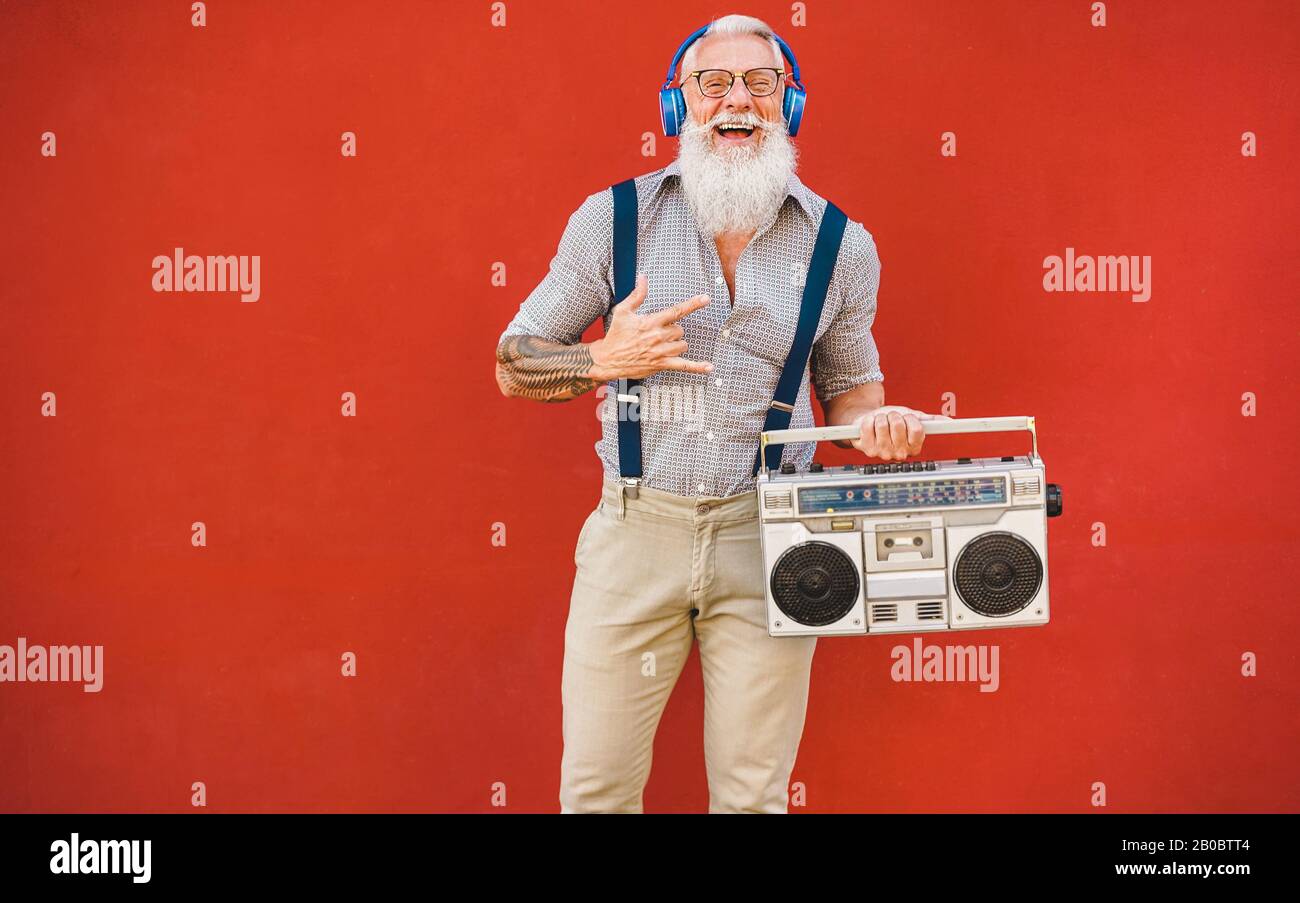 Happy senior man with boombox stereo listen music - Trendy mature guy  having fun listening with vintage radio - Joyful elderly lifestyle concept  - Foc Stock Photo - Alamy