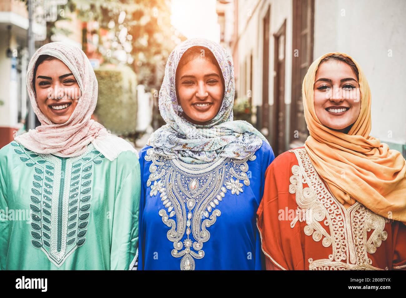 Portrait of arabian girls outdoor in city street - Young islamic women smiling on camera - Youth, friendship, religion and culture concept - Focus on Stock Photo