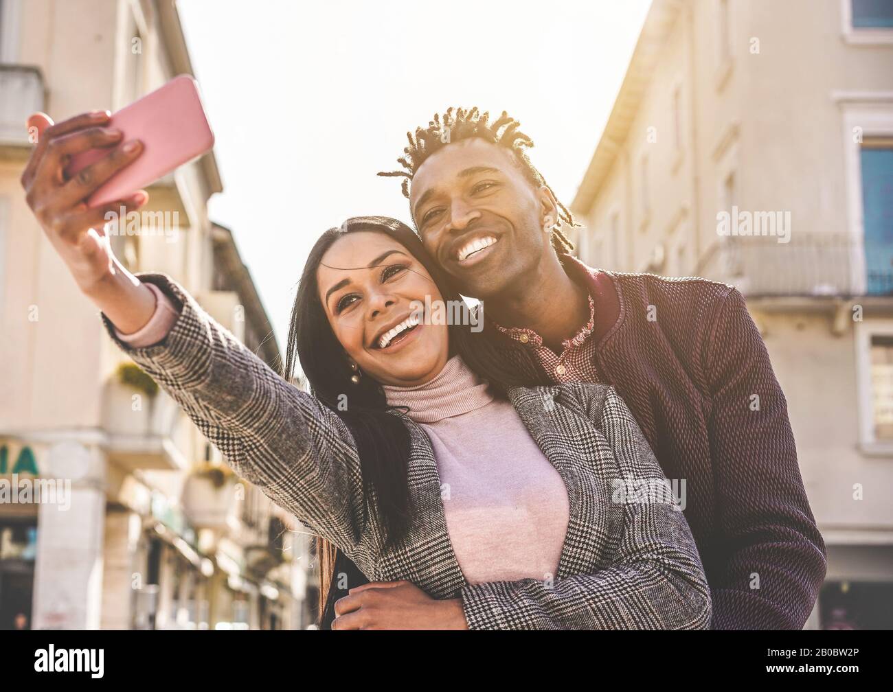 Latin couple taking selfie photo for social network story - Influencers people having fun with new trend technology - Love, fashion and relationship c Stock Photo