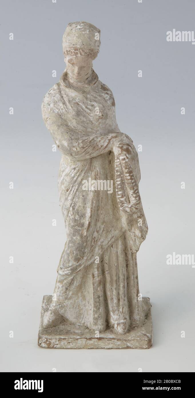 Unknown Artist, Standing Woman Holding a Chaplet, 400 BC-200 BC, terracotta, 8 1/4 in. x 2 7/8 in. (21 cm. x 7.3 cm.) Stock Photo