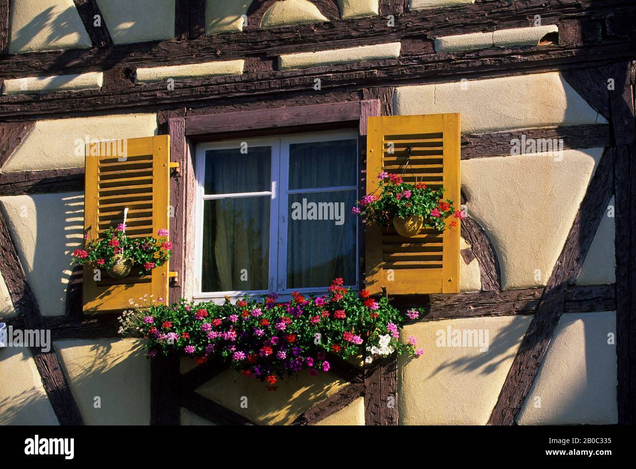 FRANCE, COLMAR, HALFTIMBERED HOUSE, WINDOW WITH FLOWERS Stock Photo