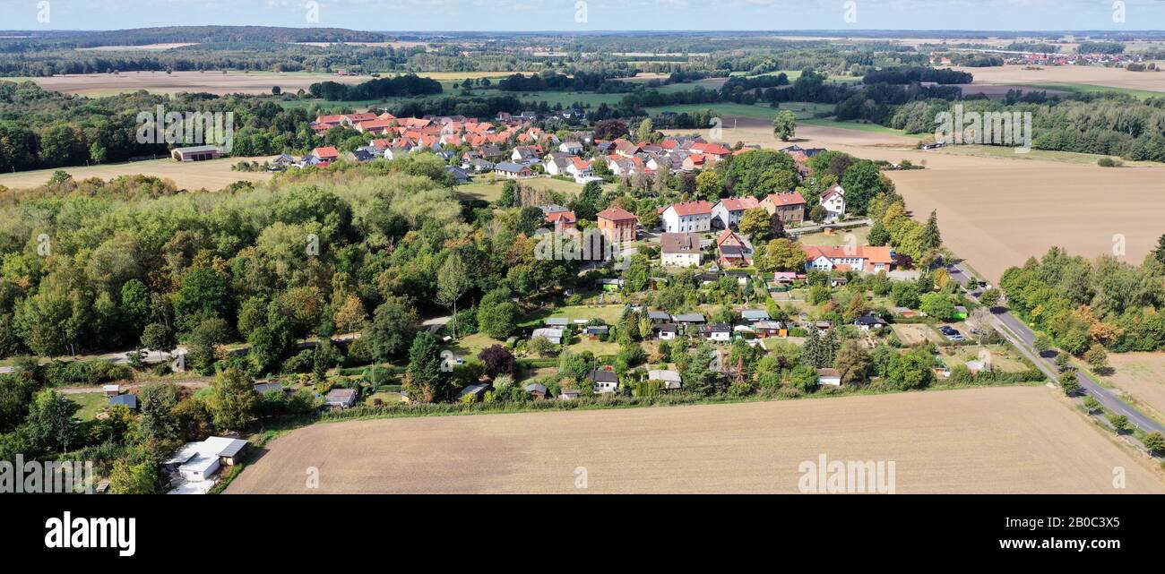 Aerial panorama of a German village at a forest next to wheat fields Stock Photo