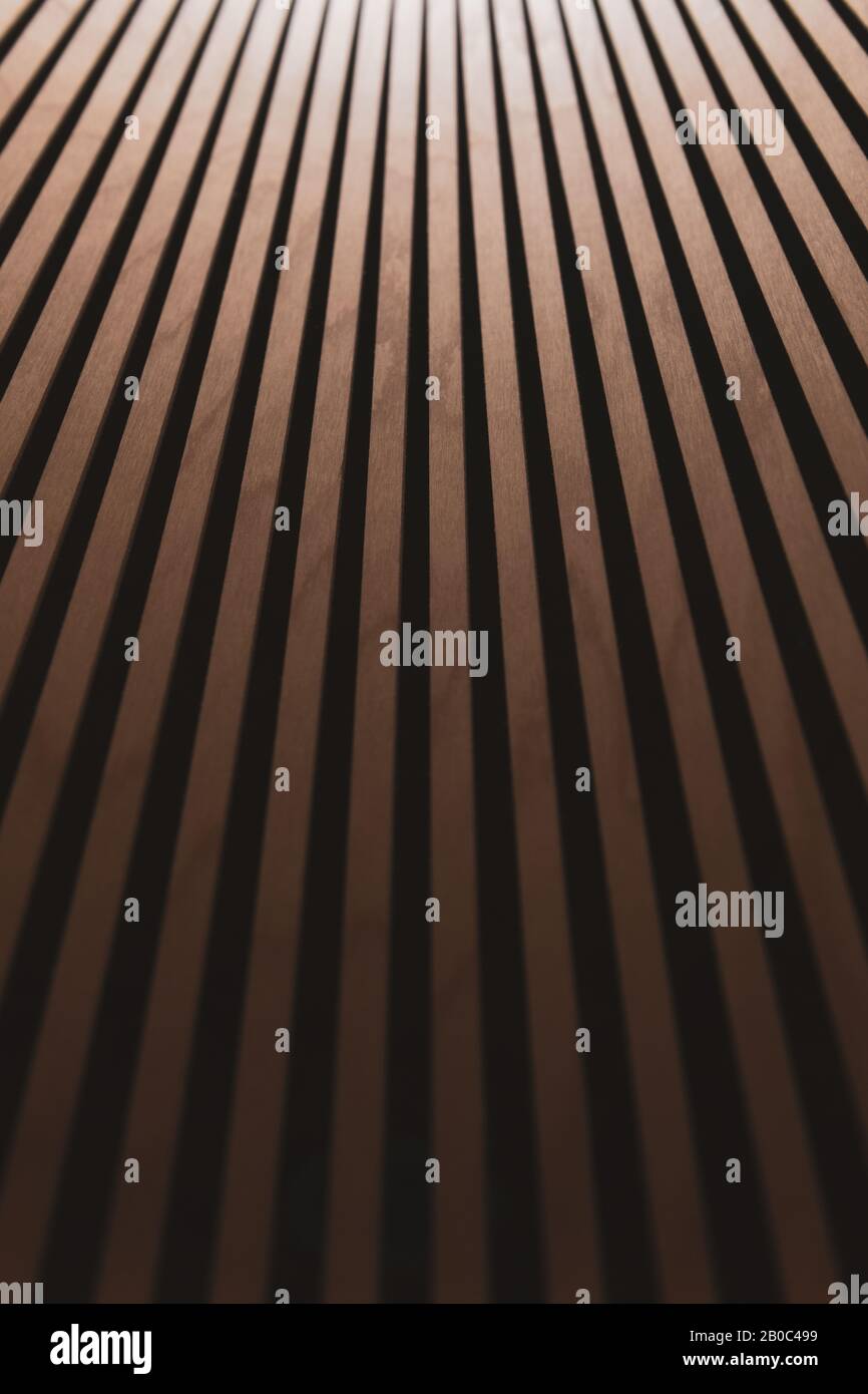 Abstract brown wooden background with gradient. Thin wooden vertical inclined planks. Inside the chandelier. Blurred vertical photo. Stock Photo