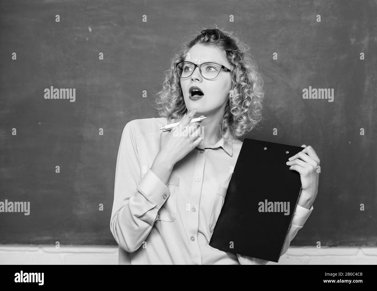 next school year. Girl prepare for exams. thinking student in glasses at blackboard. report project. back to school. essay writing. teacher with document folder. girl teacher at private lesson. Stock Photo