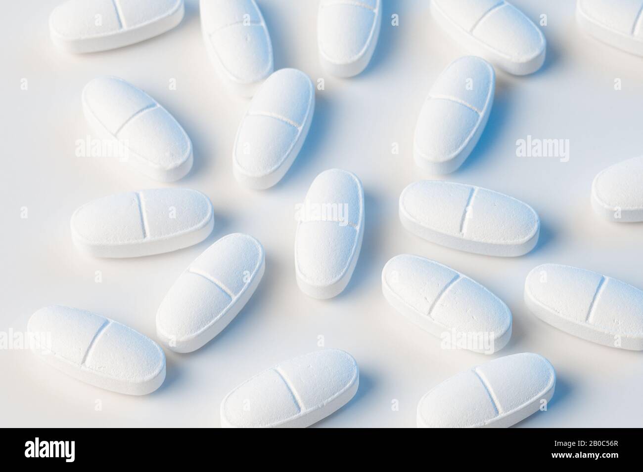 white pills on white background with blue lights Stock Photo