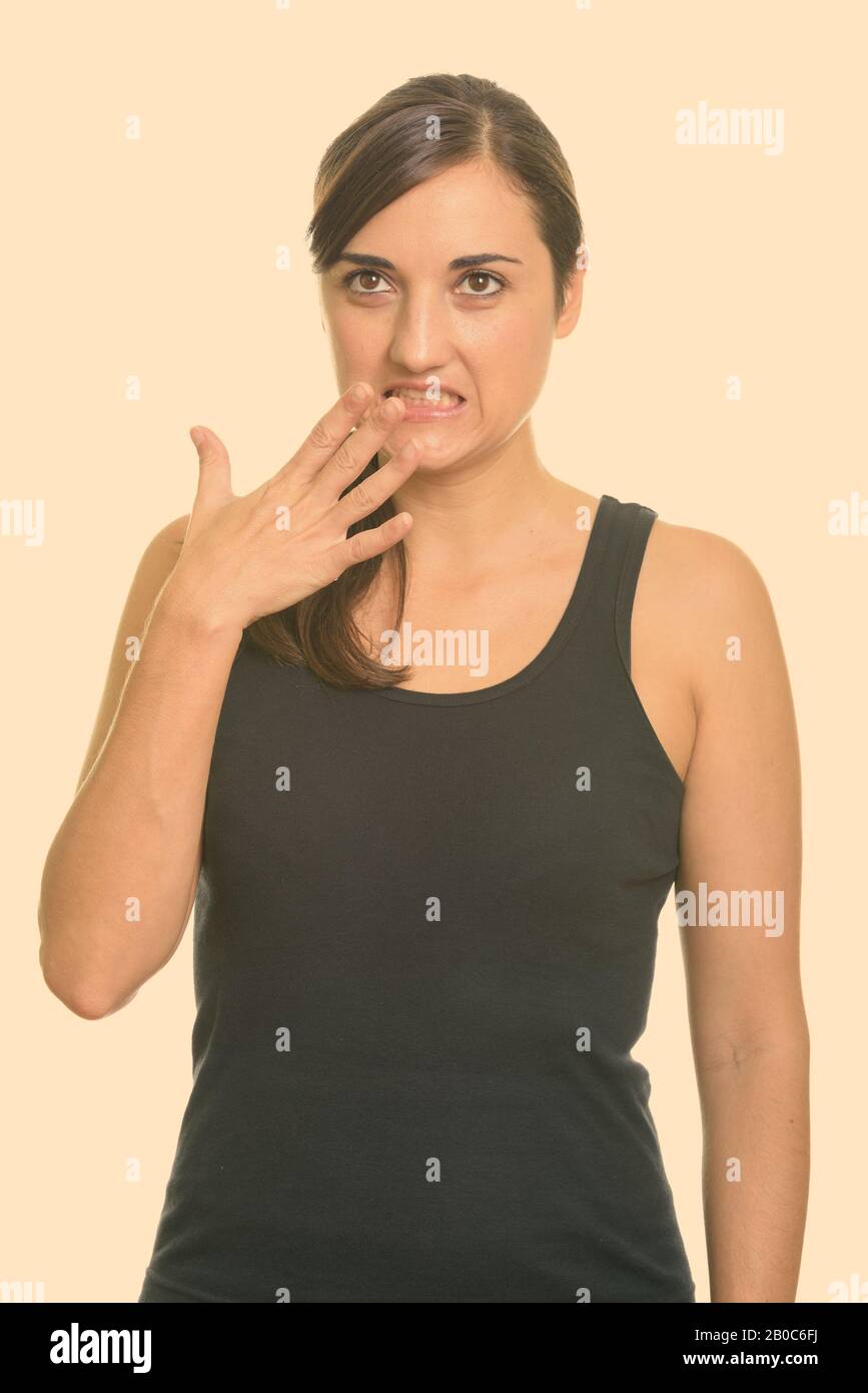 Studio shot of beautiful woman looking guilty while thinking Stock Photo