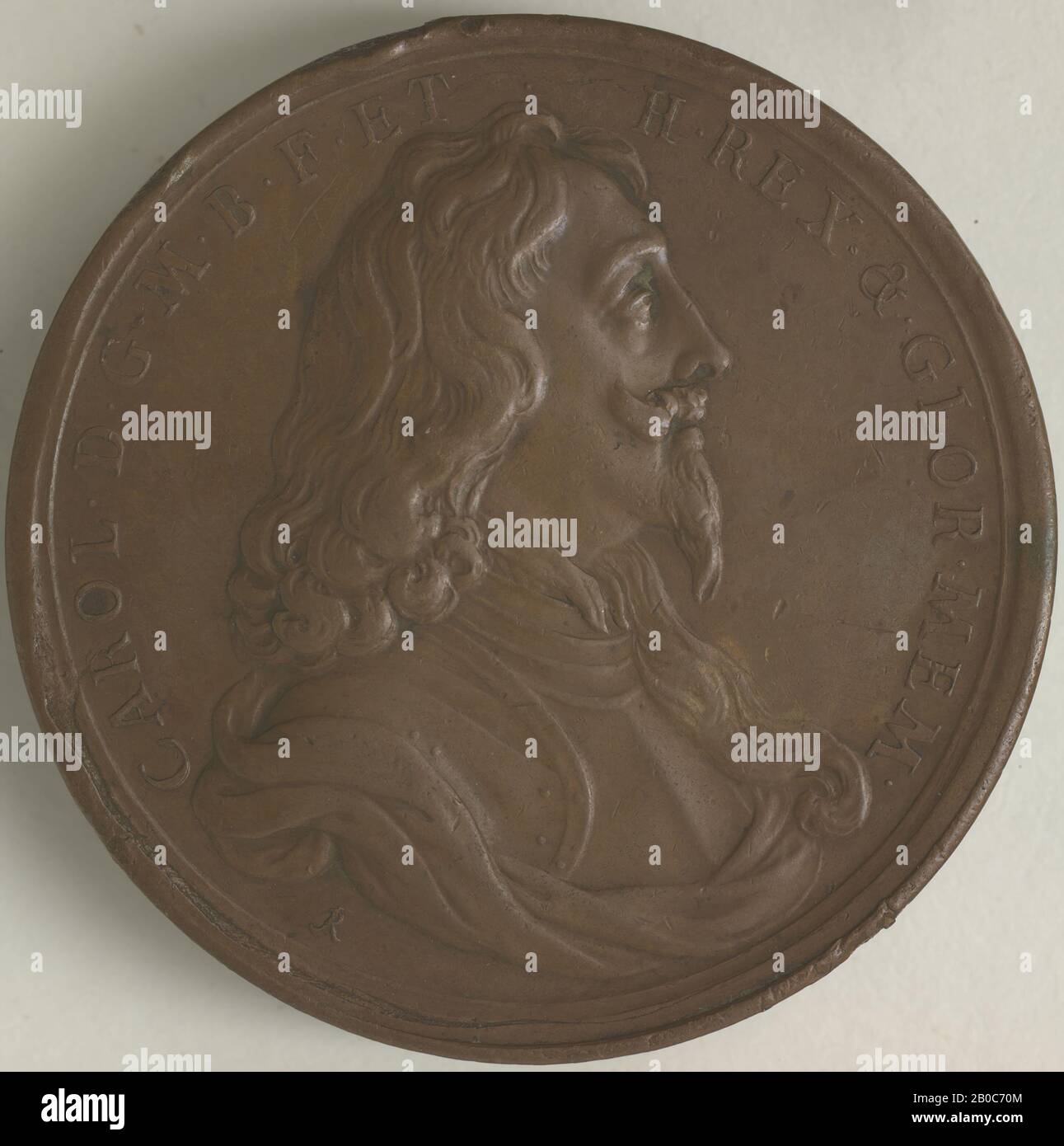 Jean Roettiers, Charles I (1600-1649), King of England 1625-1649, ca. 1670, copper, 1 15/16 in. (5 cm.), Charles I's deep distrust of and frequent clashes with Parliament characterized his reign (1600-1649). The disagreements culminated in the English Civil War, which lasted from 1642 until Charles I's surrender and execution in 1649. After a decade of unsteady Commonwealth rule, Parliament eventually restored Charles I's rightful heir, Charles II, to the throne in 1660. Charles II ordered this posthumous medal of Charles I to be struck in honor of his father. Ironically, the reverse of the me Stock Photo