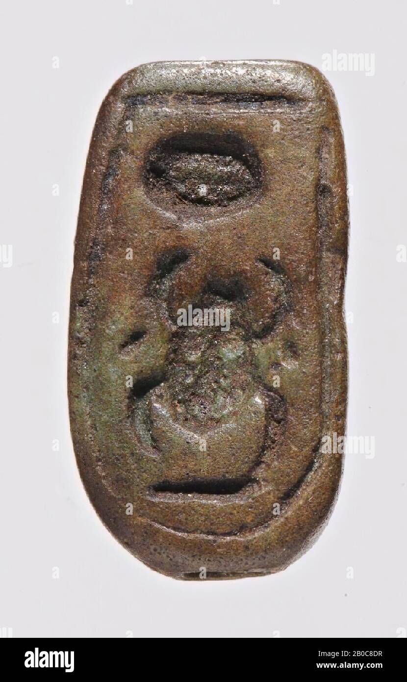 button seal, lion, lying, Mencheperre, The brown button seal with traces of a green glaze layer has the shape of a lying lion with a space between the base and the belly of the animal. The lion is a symbol for the king. In the sealing plane three hieroglyphs are placed in low relief within a framing groove, which together possibly form the name of Thutmose III (Men-cheper-re) although the sign is placed at the bottom and consists of no more than one line. However, the deviating place of this sign is more common (see Jaeger (1982): Scarabées Menkhéperrê, p. 29 no. 5). Stock Photo