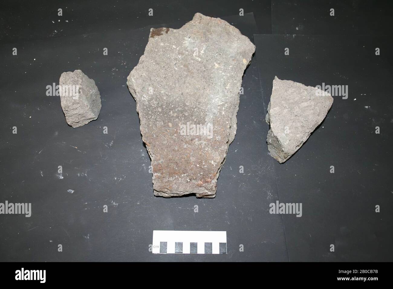 3 fragments of a stone grindstone, millstone, fragments, stone, 30.5 x 20 x 5 cm (largest fragment), Netherlands, unknown, unknown, unknown Stock Photo