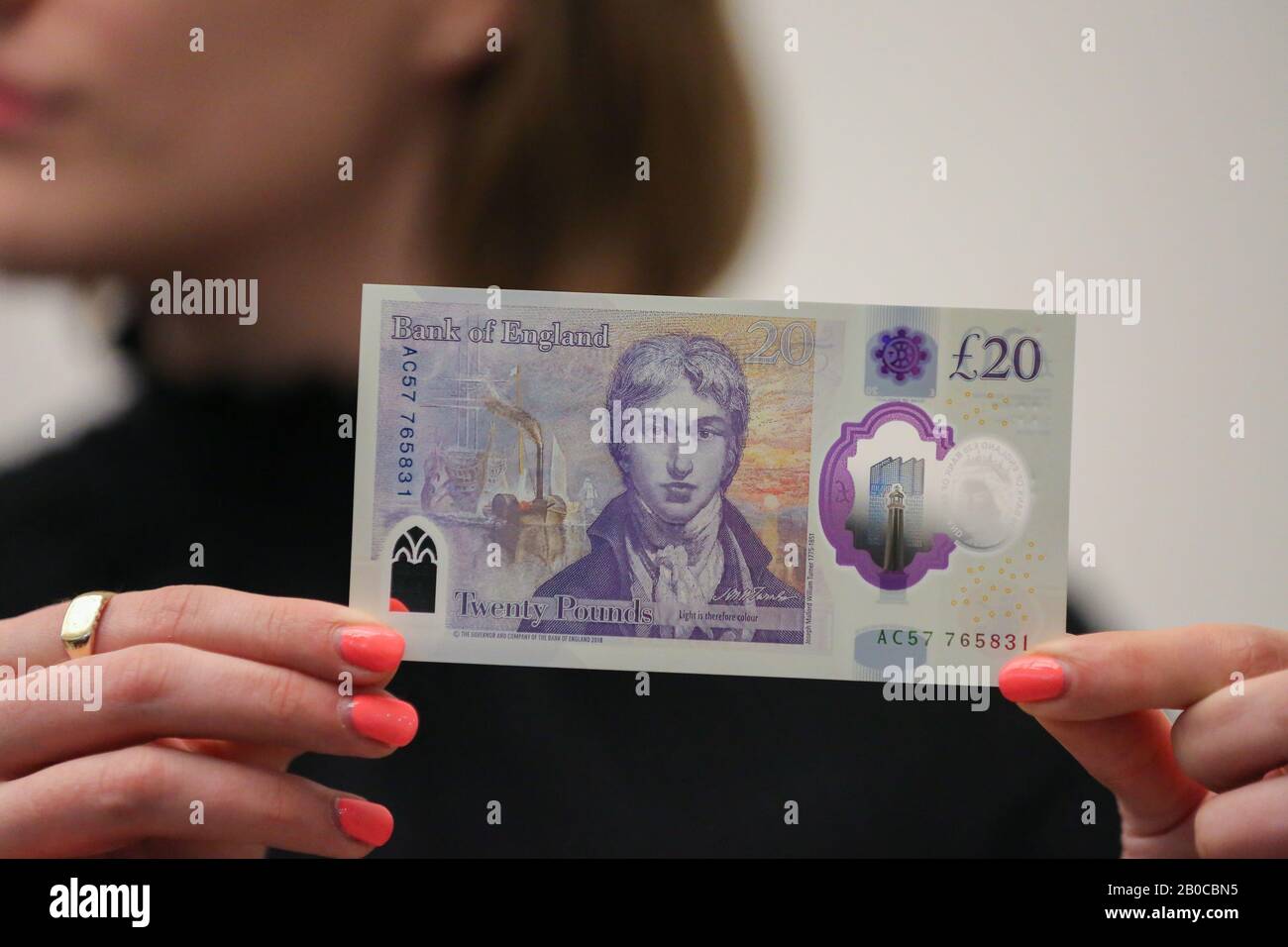 Tate Britain, London, UK 20 Feb 2020 - A staff member holds the new £20 ...