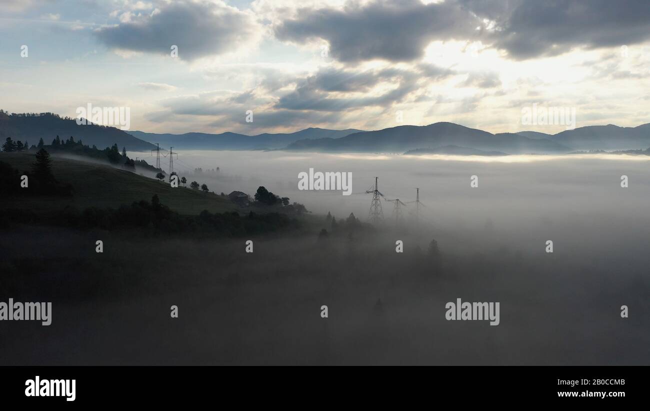 Aerial view of colorful mixed forest shrouded in morning fog on a ...