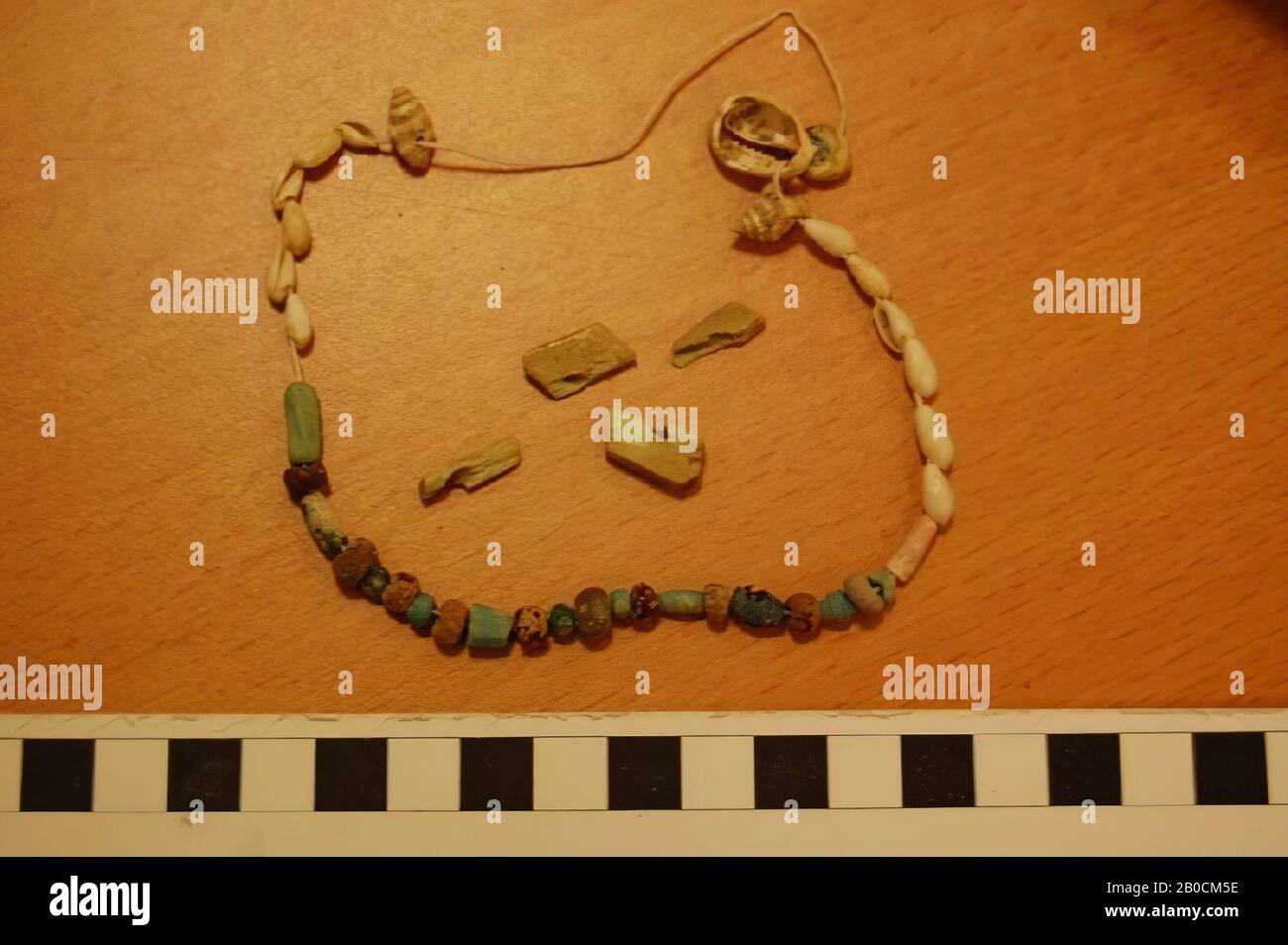 Necklace with 23 beads and 15 shells 4 loose broken pieces, grave inventory, ornament, carnelian, blue stone, glass, amber, Different, beads range from 2 mm to 1 cm length, shells from 7 mm to 17 mm length , Islamic Period 1250-1600 AD, Jordan Stock Photo
