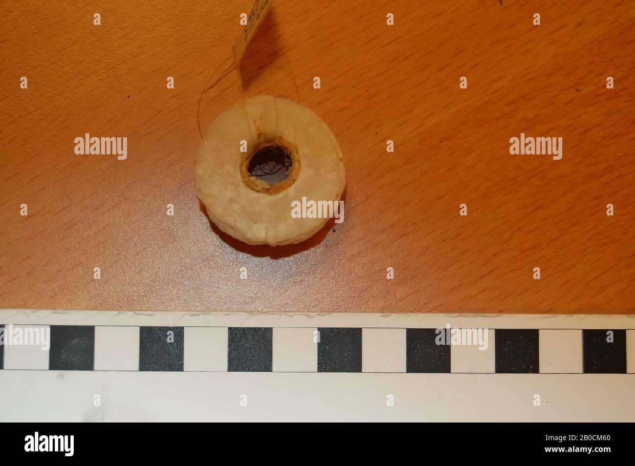 Alabaster disc or bead, bad condition, tools, stone, alabaster, D 3.3 cm, D hole 0.9 cm, H 2.05 cm, Iron Age I, phase H 1150-1050 BC, Jordan Stock Photo