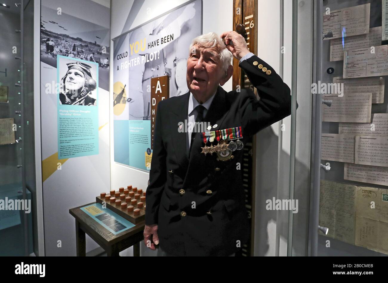World War Two veteran Peter Lemon, a Wireless Operator Air Gunner and bomber crew, checks his height on a fighter pilot exhibit during the press launch for the Battle of Britain 80th anniversary commemorations at the Biggin Hill Memorial Museum in Kent. Stock Photo