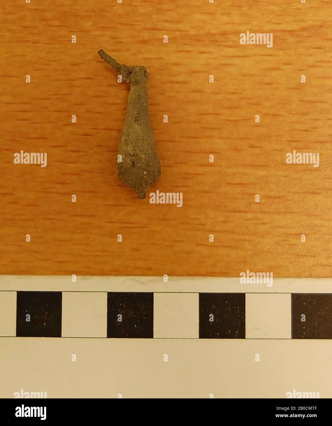 Drop shaped pendant of bronze, fragment of an earring ?, corroded, tomb inventory, ornament, bronze, D 0.1 cm, H 3 cm, Islamic Period 1250-1600 AD, Jordan Stock Photo
