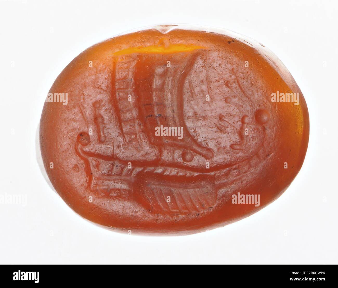 Vz: a large sailing ship with many oars and a small helmsman at the helm, a statue (?) With a high polos sitting on the bow., Gem, intaglio, ringstone, carnelian, Color: orange, Shape: oval, Machined: edge front rounded, Method: shallow modeling with flattish drill, detailing with thin rounded wheel grooves and several bouterolle pellets., 15 x 11 mm, D. 2 mm, end of 1st century BC. -25 Stock Photo