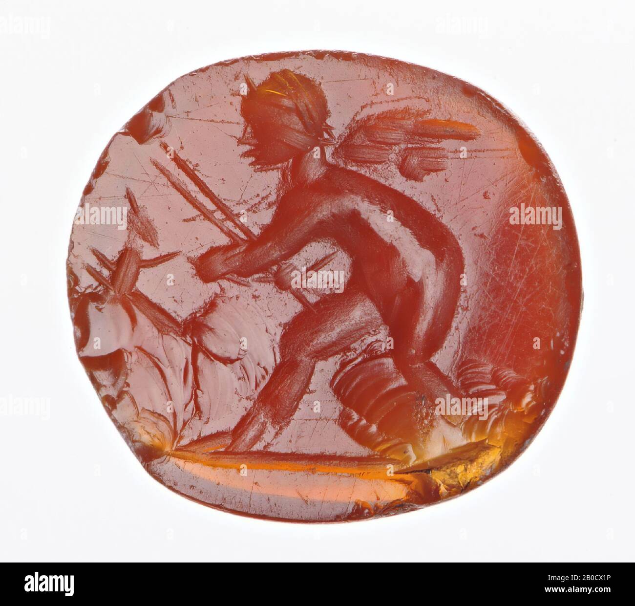 Vz: the little god holds a dog with his left hand, in the right hand he has two spears., Gem, intaglio, ringstone, carnelian, Color: orange-red, Shape: oval, Processing:, Method of manufacture: body modeling with very large rounded drills, detailing with a few rounded wheel grooves., 11 x 10 mm, D. 2 mm, end of the 1st century BC. - early 1st century AD. -25 BC Stock Photo
