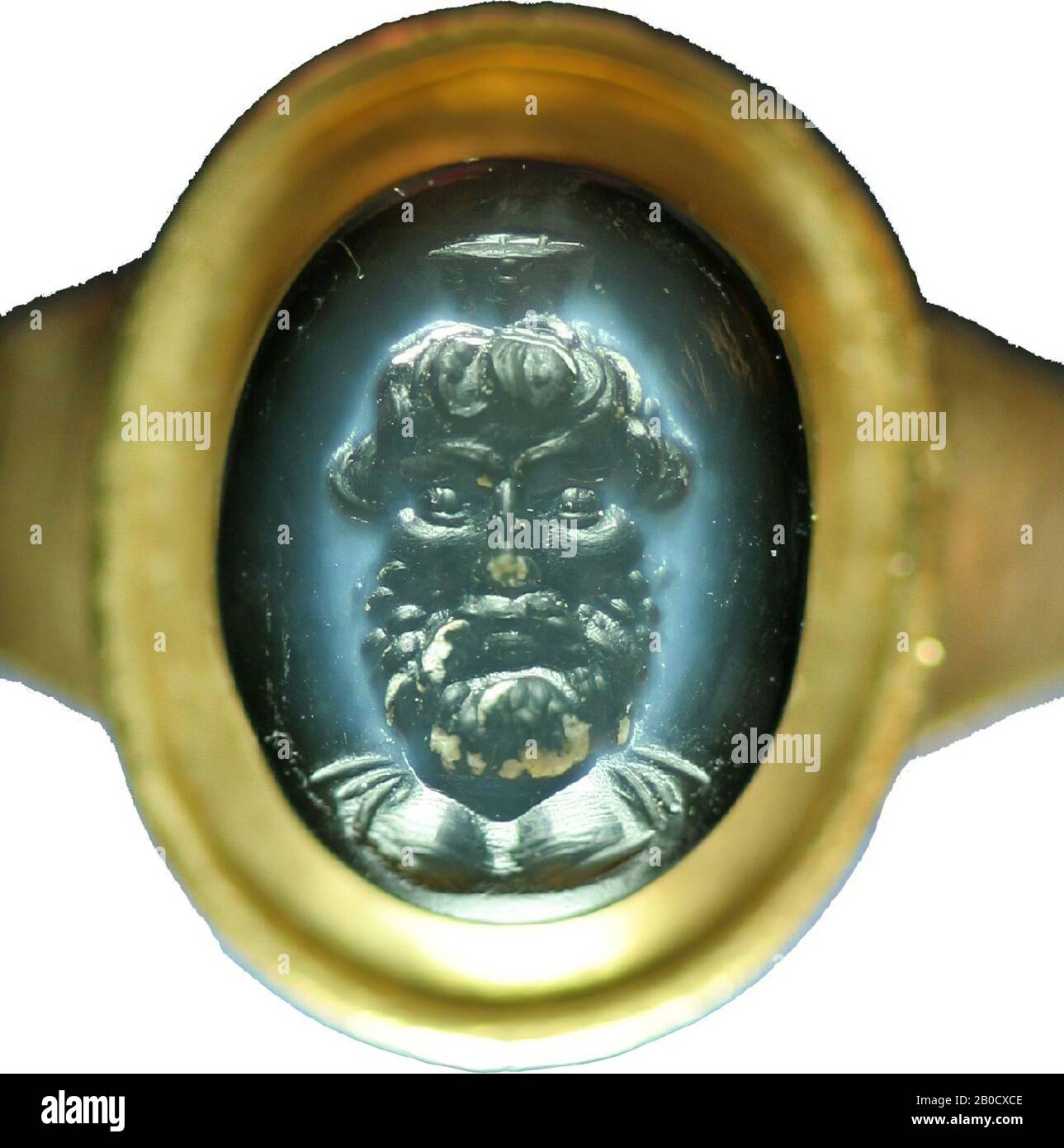 Vz: a round and small head is depicted with a curly beard and loose locks falling down the temples, on the head a small modius., Gem, intaglio, ringstone, agate, nicolo, Color: black Stock Photo