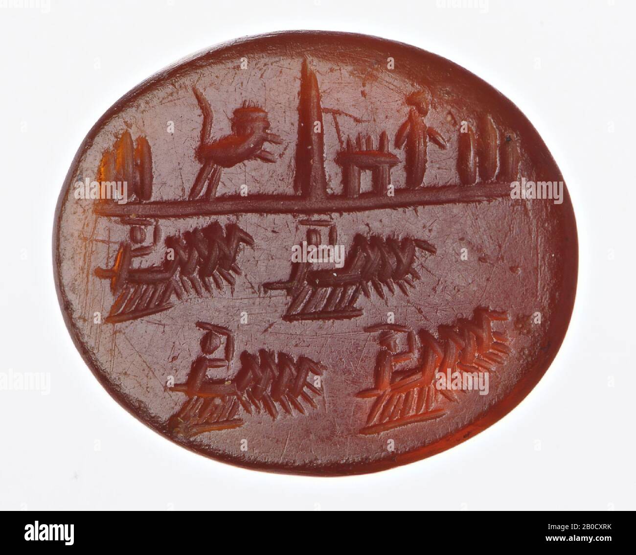 Vz: four quadrigas race to the right, each with a driver who has the reins in his right hand and a whip in the other, the spina is visible in the background and several objects are on the spina: a temple, several metae, a statue of a god or goddess and a big lion., gem, intaglio, ringstone, carnelian, Color: brown-red, Shape: oval, Processing: edge cut back at the back compared to the front, Method: modeling with several short rounded wheel grooves., 11.5 x 10 mm, D. 3 mm, 2nd century AD. 100-200 AD Stock Photo
