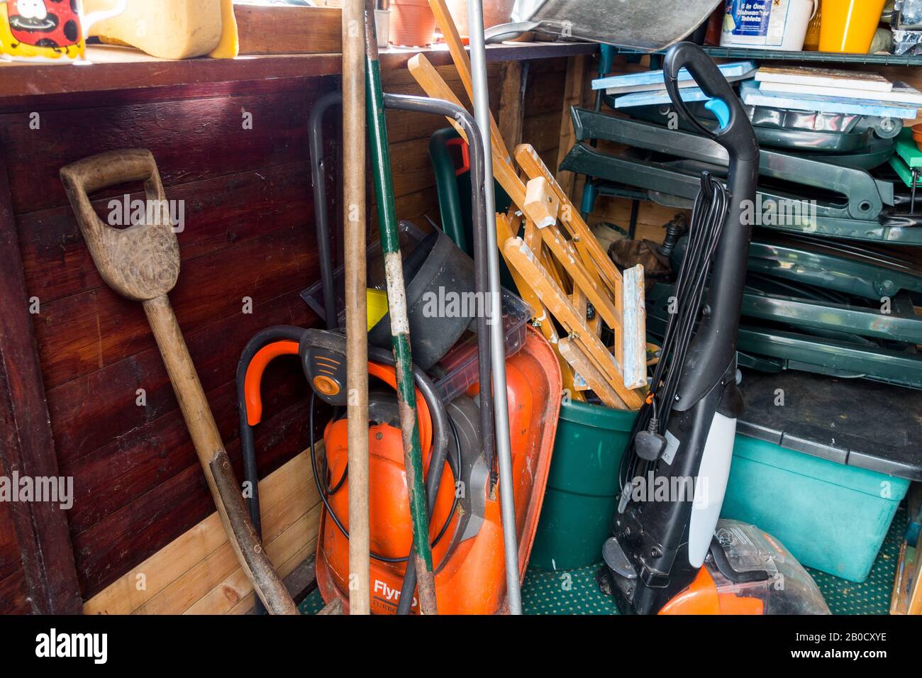 garden shed with door open showing disorganised contents. Scotland UK Stock Photo