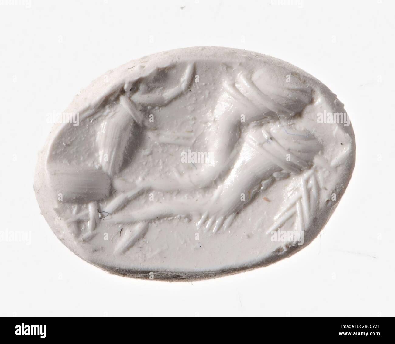 Vz: a Cupid, with the hair in a roll around his head, has a whip in his right hand and with the other he holds the reins, the reins are attached to a pair of dolphins stretched in front of the chariot ., gem, intaglio, ringstone, carnelian, Color: red, Shape: oval, Machining: front convex, edge cut at the back compared to front, Method: body modeling with very large rounded drills, detailing with thick slipshod wheel grooves ., 11.5 x 9 mm, D. 4.5 mm, 2nd century AD. 100-200 AD Stock Photo