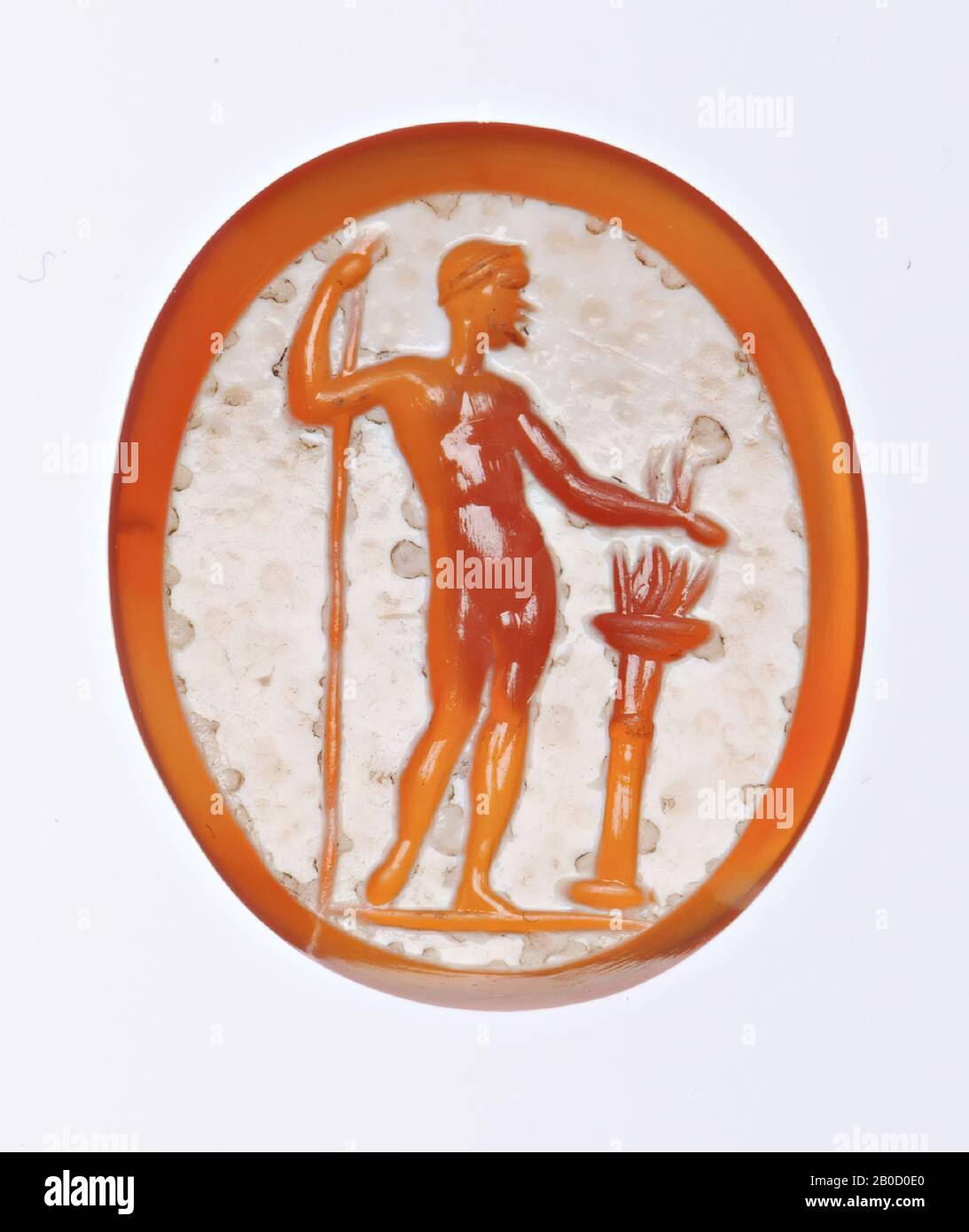 F: man standing leaning to the left on a spear, he projects his right arm to the column with fire, gem, intaglio, carnelian, nicolo, Color: white Stock Photo