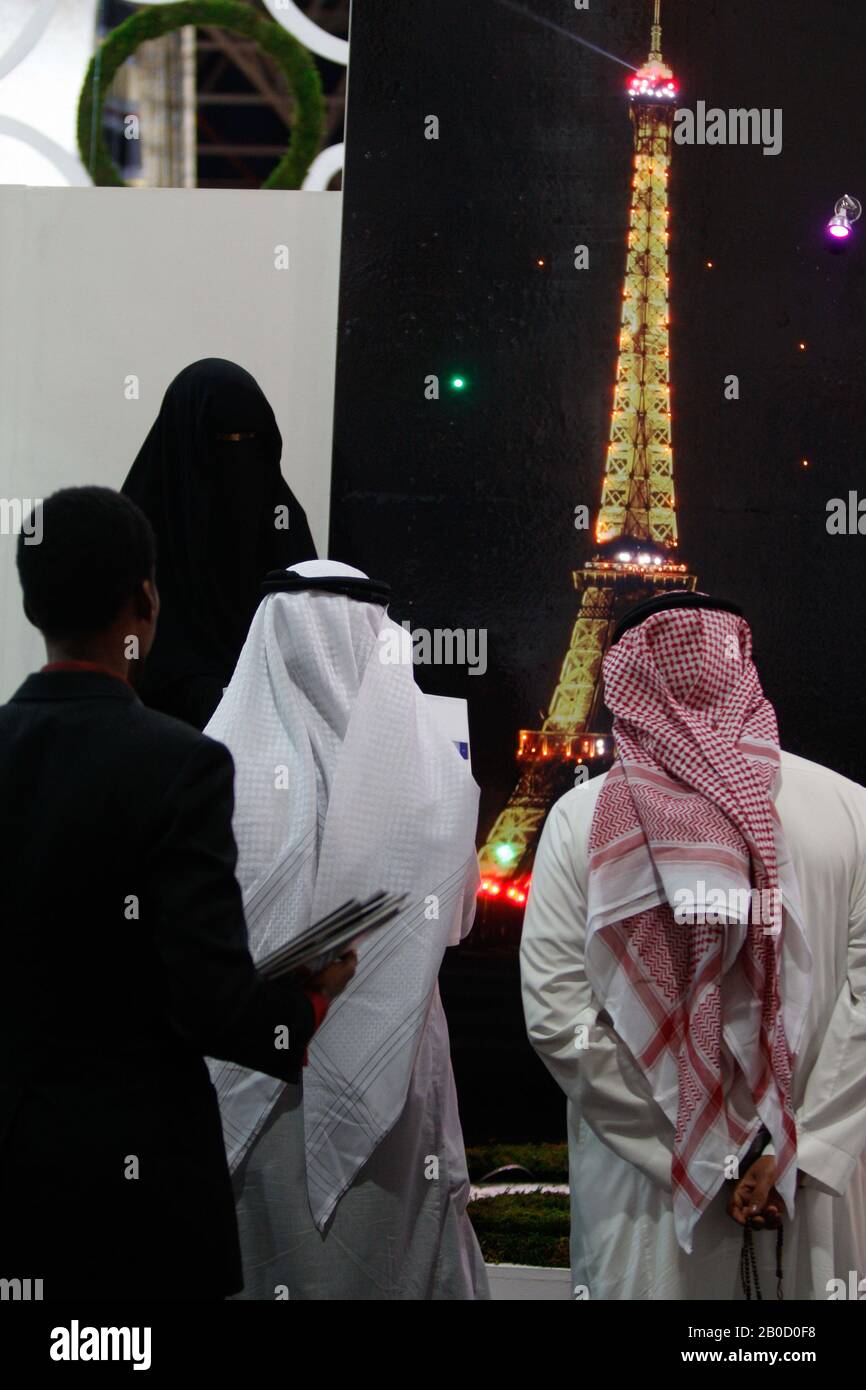 A Woman promotes to Saudi men a travel program during an exhibition in Jeddah, Saudi Arabia. Stock Photo