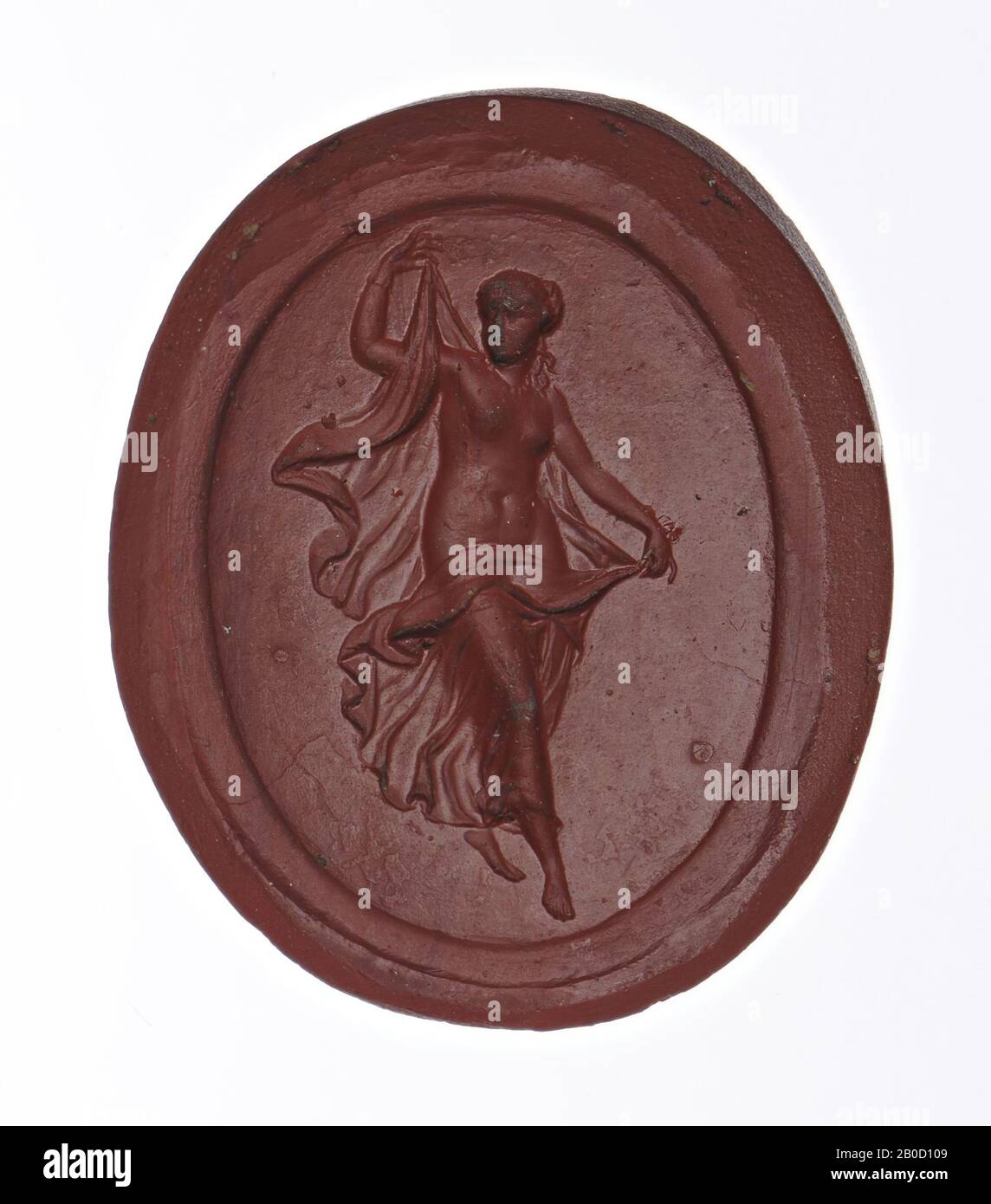 Vz: dancer turned to the left, left leg stretched backwards, right leg bent, drapery with arms stretched behind the back, covering the upper legs, gem, intaglio, paste, Color: red-brown mat opaque, Shape: oval, standing , Machining:, Method of manufacture: 30 x 24 mm, D. 6 mm, wt. 7.54 gr., 18th Stock Photo