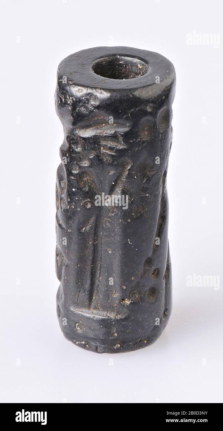 Vz: standing god and pleading goddess, 2 winged sphinxes and 2 deer, coil seal, hematite, Color: black, Shape: cylinder, Processing:, Method: L. 23 mm, Diam. 9.5 mm Stock Photo