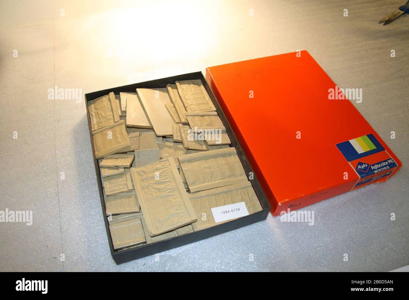 printing, plastic, cardboard, Color: yellow print, orange box, Shape: box, 19.4 x 3.7 x 26.6 cm Stock Photo