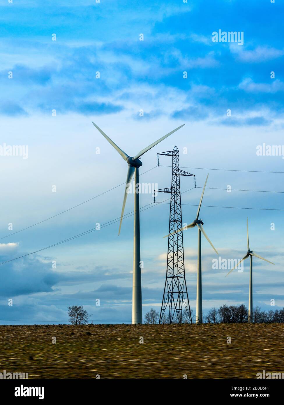 Wind turbines and electricity pylon, Chatellerault, Vienne, France. Stock Photo