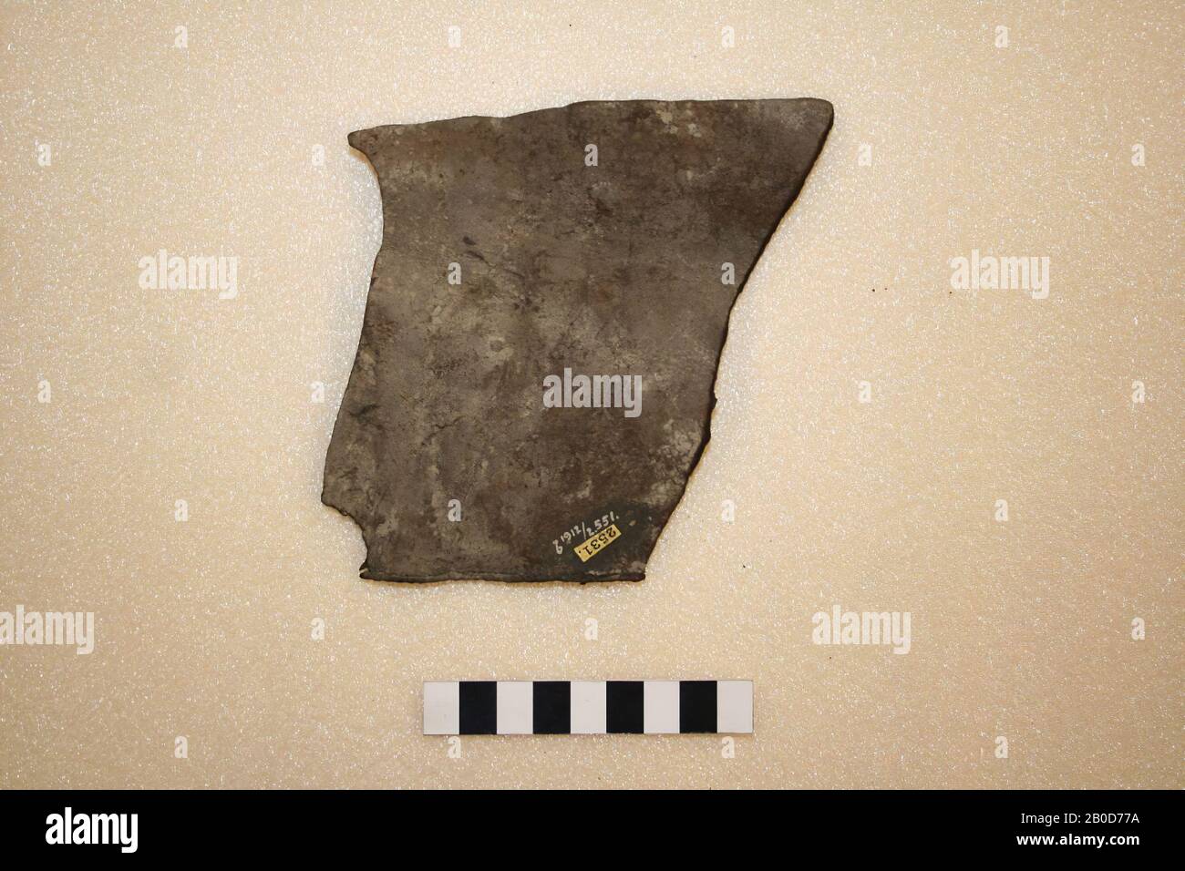 Fragment of leather. One side of the leather is provided with regular sewing holes (visible on the side). Probably medieval. Compare b 1912 Stock Photo
