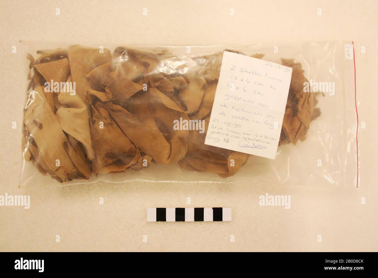 Fragments of mummy wrappings. Sticker on bag: '248'. Note: '20 -5-'96, 2 pieces of linen 12 x 6 cm and 10 x 6 cm used for the restoration of the feet of Gray 15. 23-09-'96, piece of linen of 6 x 20 cm used for restoration from Gray 18. C. van Battum. ', cloth, fabric, linen, Egypt Stock Photo