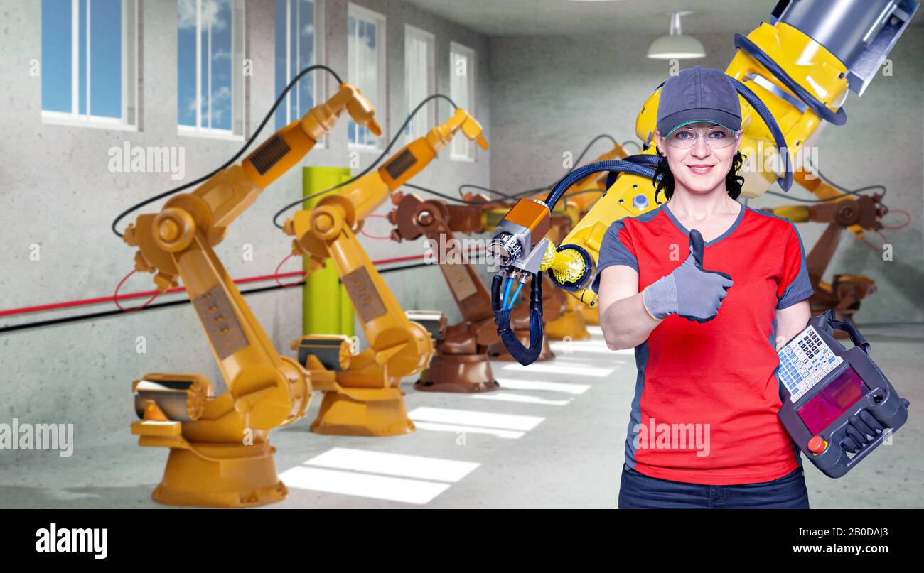 A young female technician while machine constructing in a manufacturing plant Stock Photo