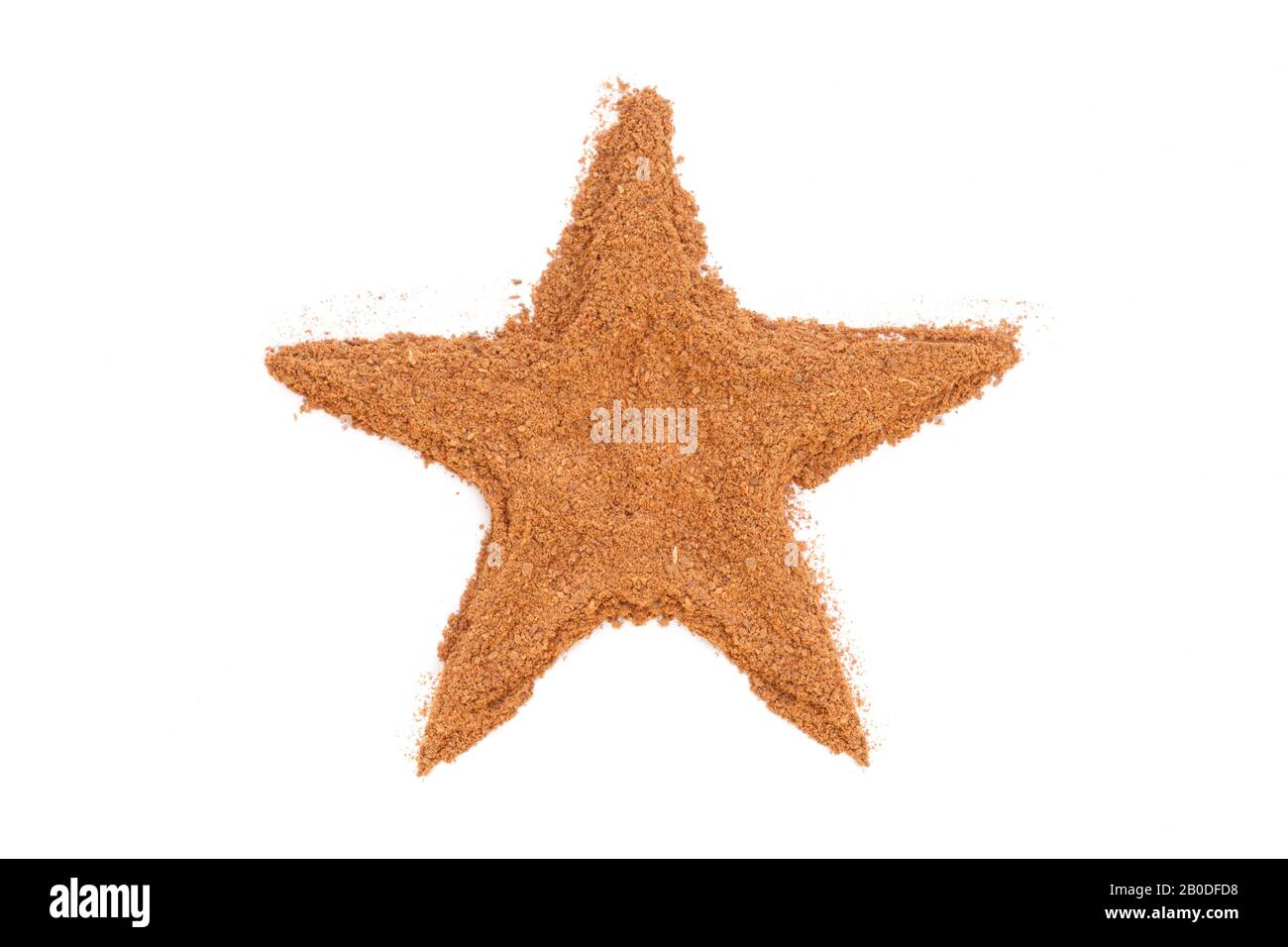 Heap of ground Cinnamon isolated in star shape on white background.  As a spice or condiment cinnamon sold in the form of sticks or a hammer. Stock Photo